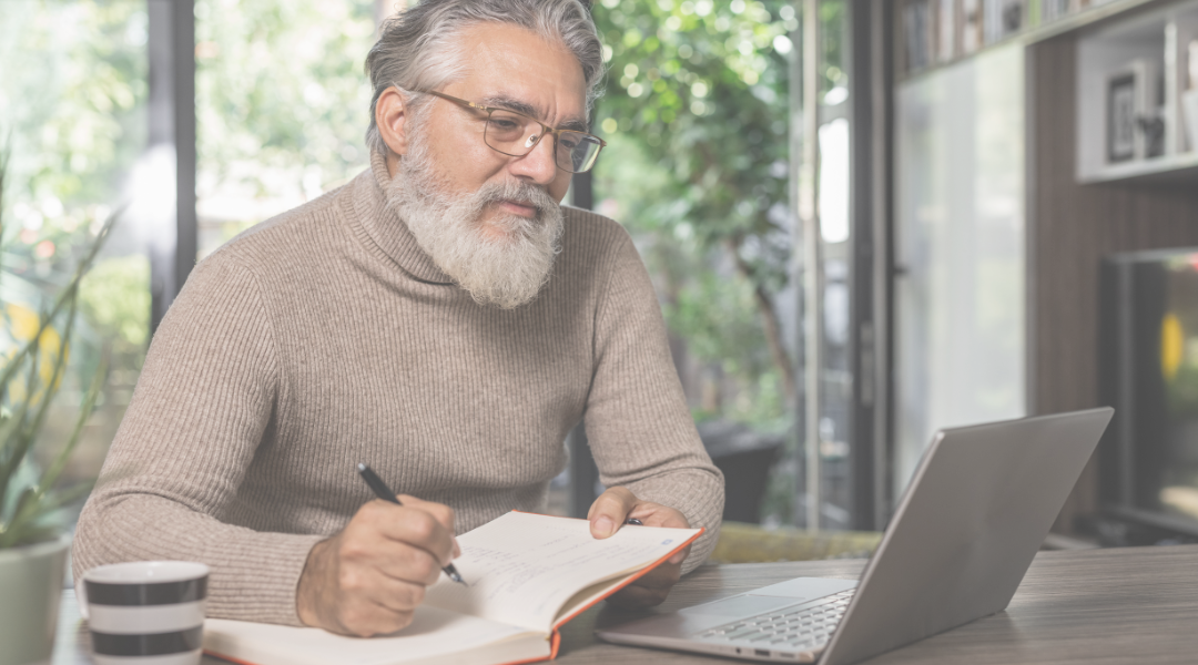 An adult man studying on a desk